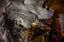 A miner drilling underground