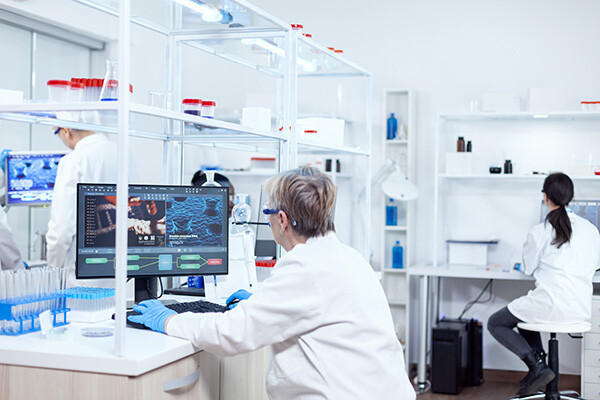 Scientists in lab coats working in a pharmaceutical lab